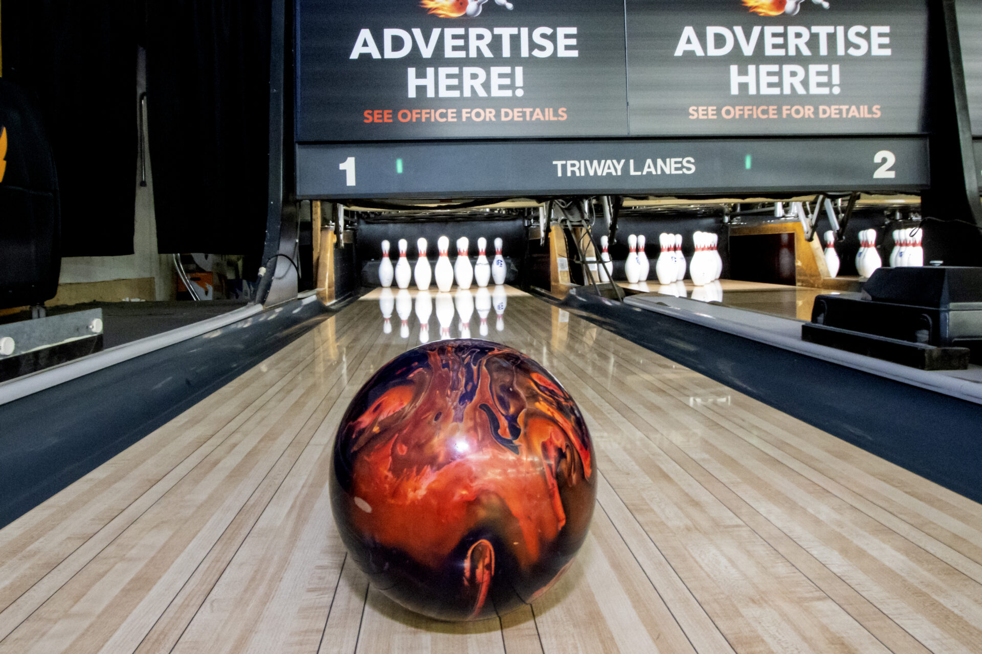 ballerz sports club bowling alley with bowling ball going down the lane towards the pins